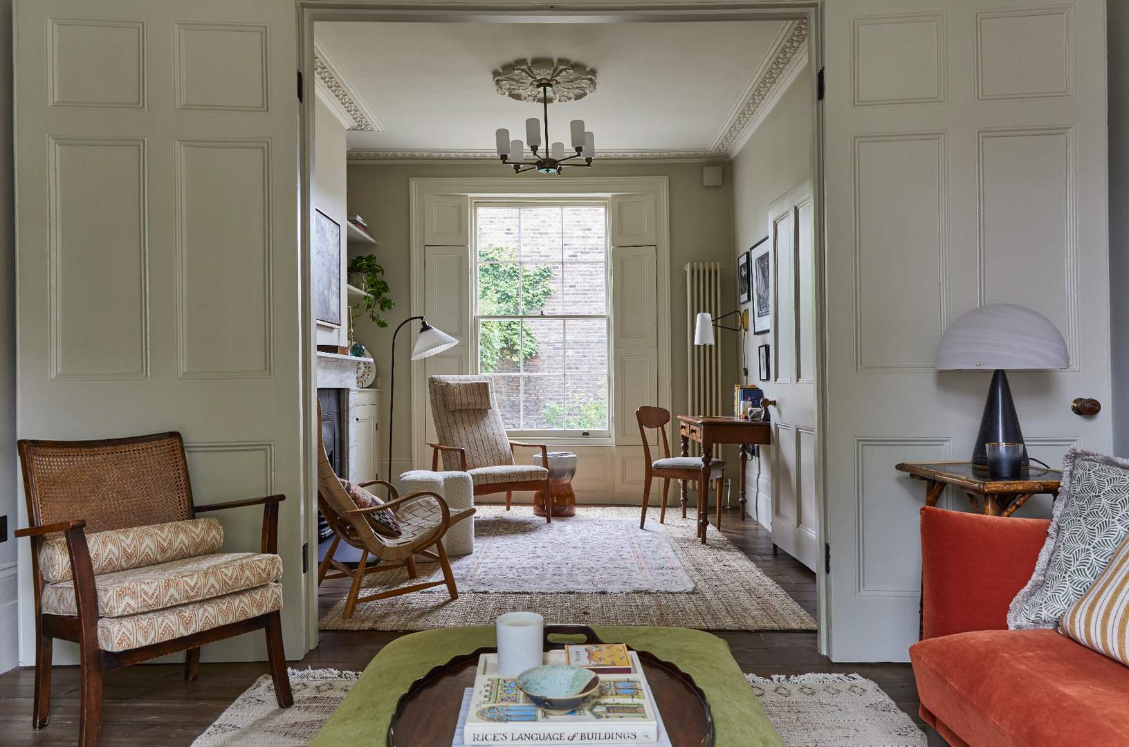 Period sitting room seen through a pair of panelled doors