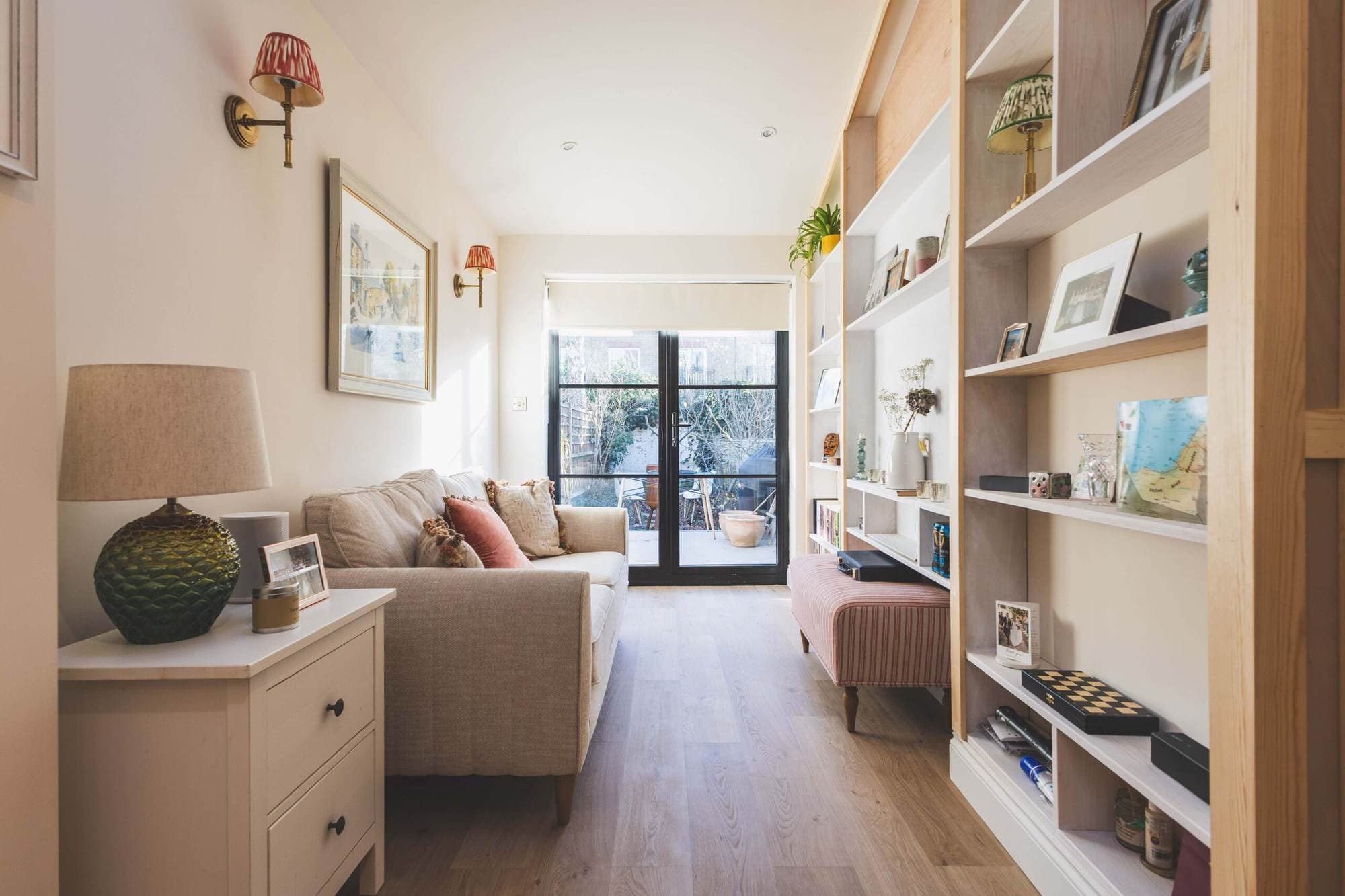 Narrow living space leading to glazed doors at the back of an extension
