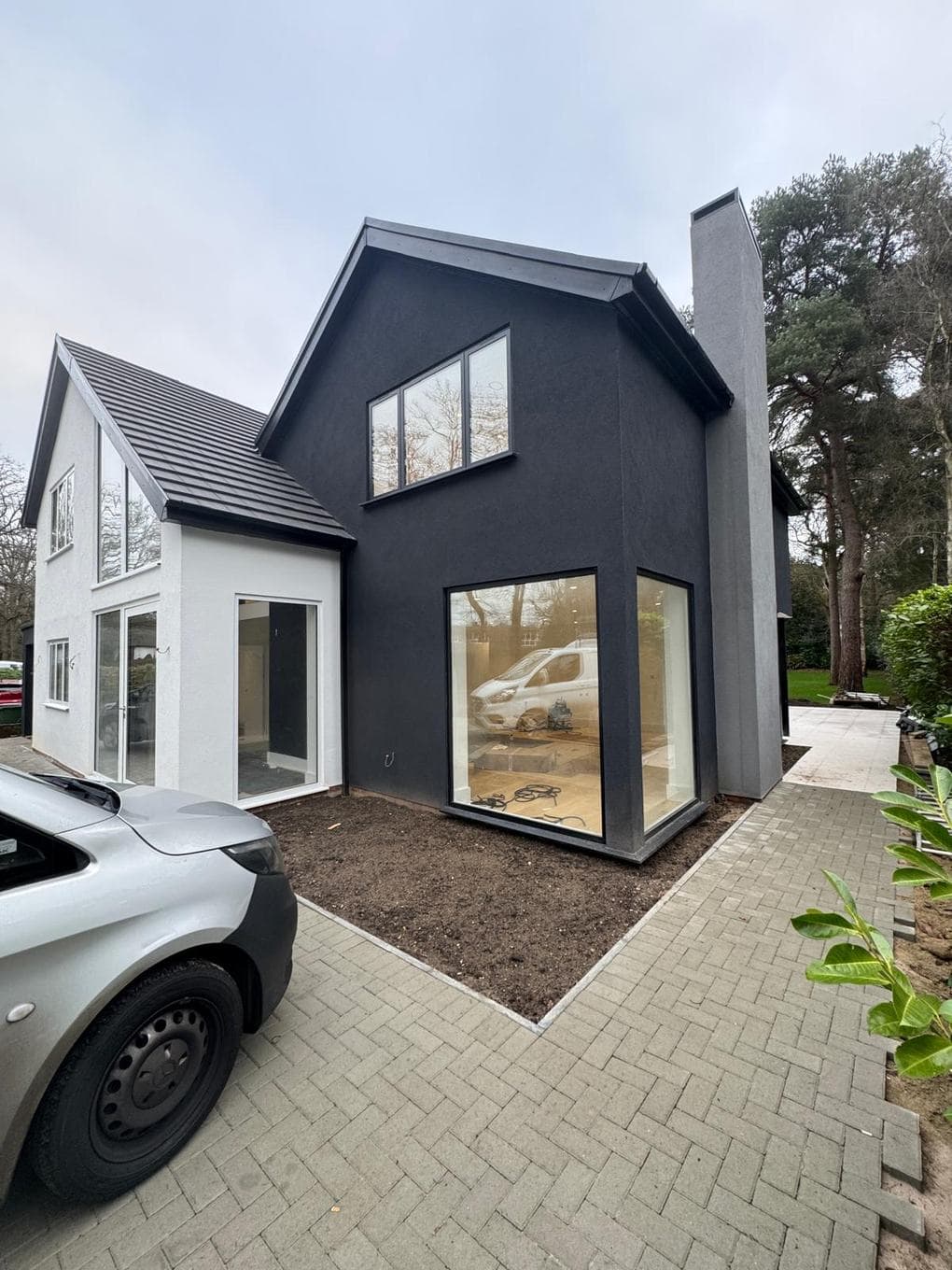Dark-clad gable extension with large picture window