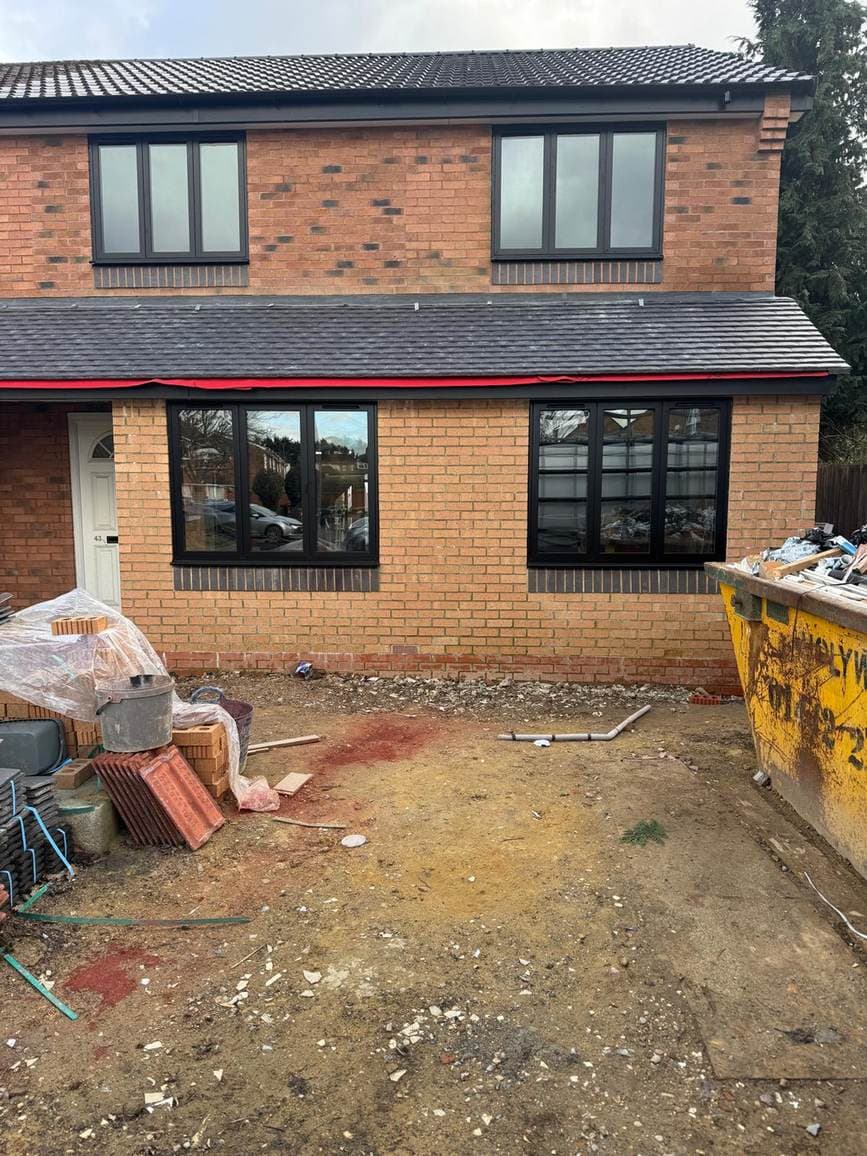 Rear extension under construction with new black windows fitted