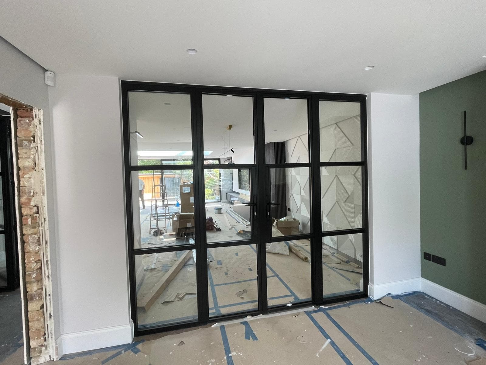 Black steel-look internal glazed screen with double doors