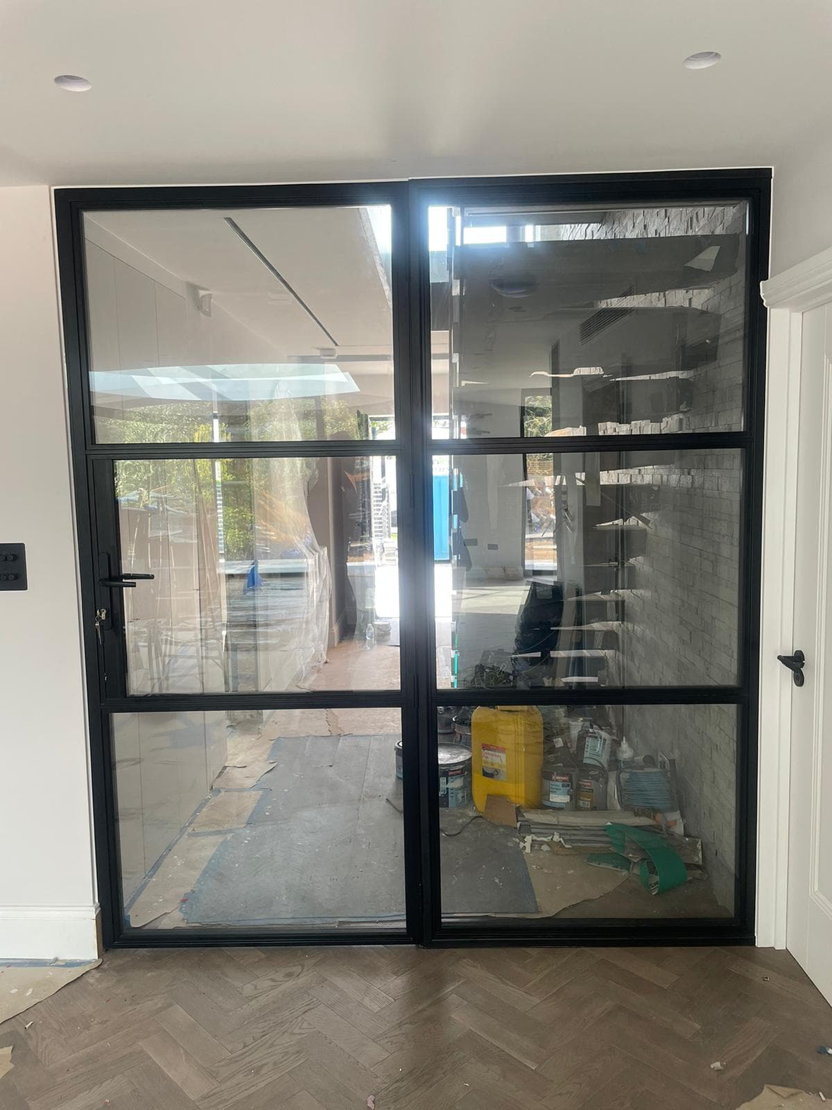 Black steel-look glazed door set in an internal wall