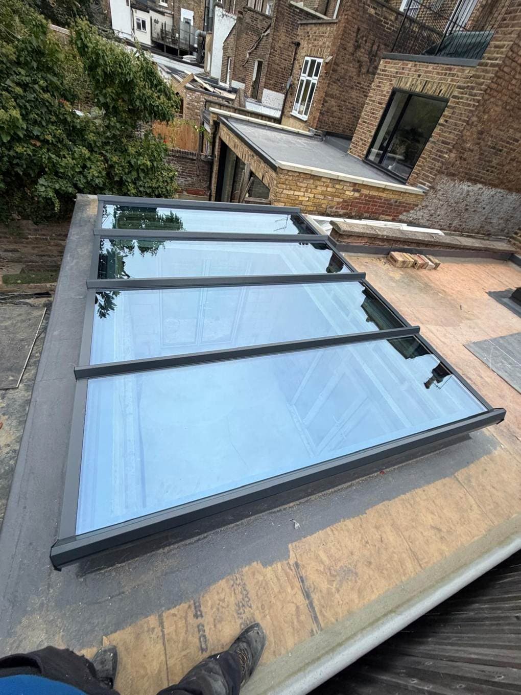 Long flat glass rooflight on an extension roof