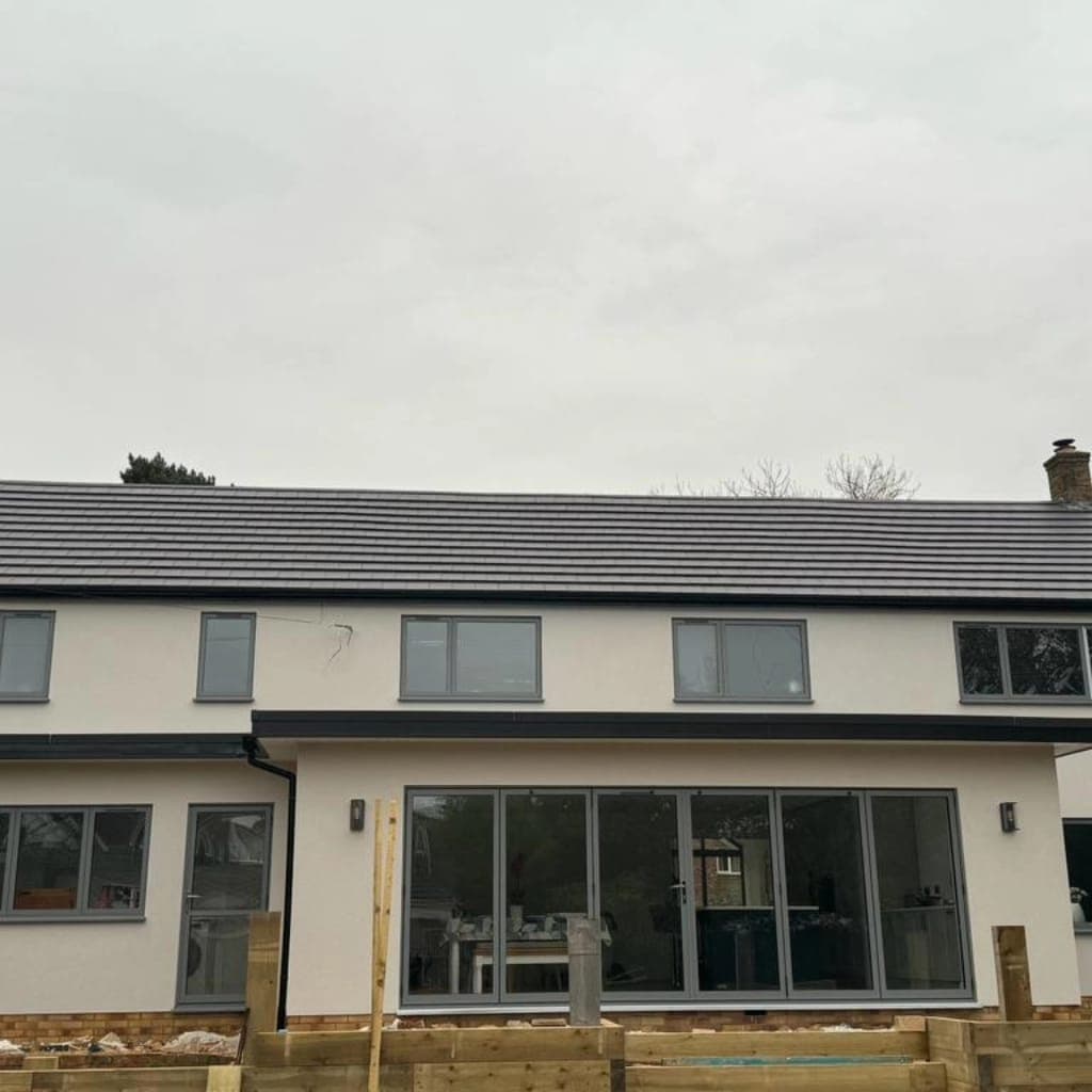 Rendered rear elevation with grey sliding doors and windows