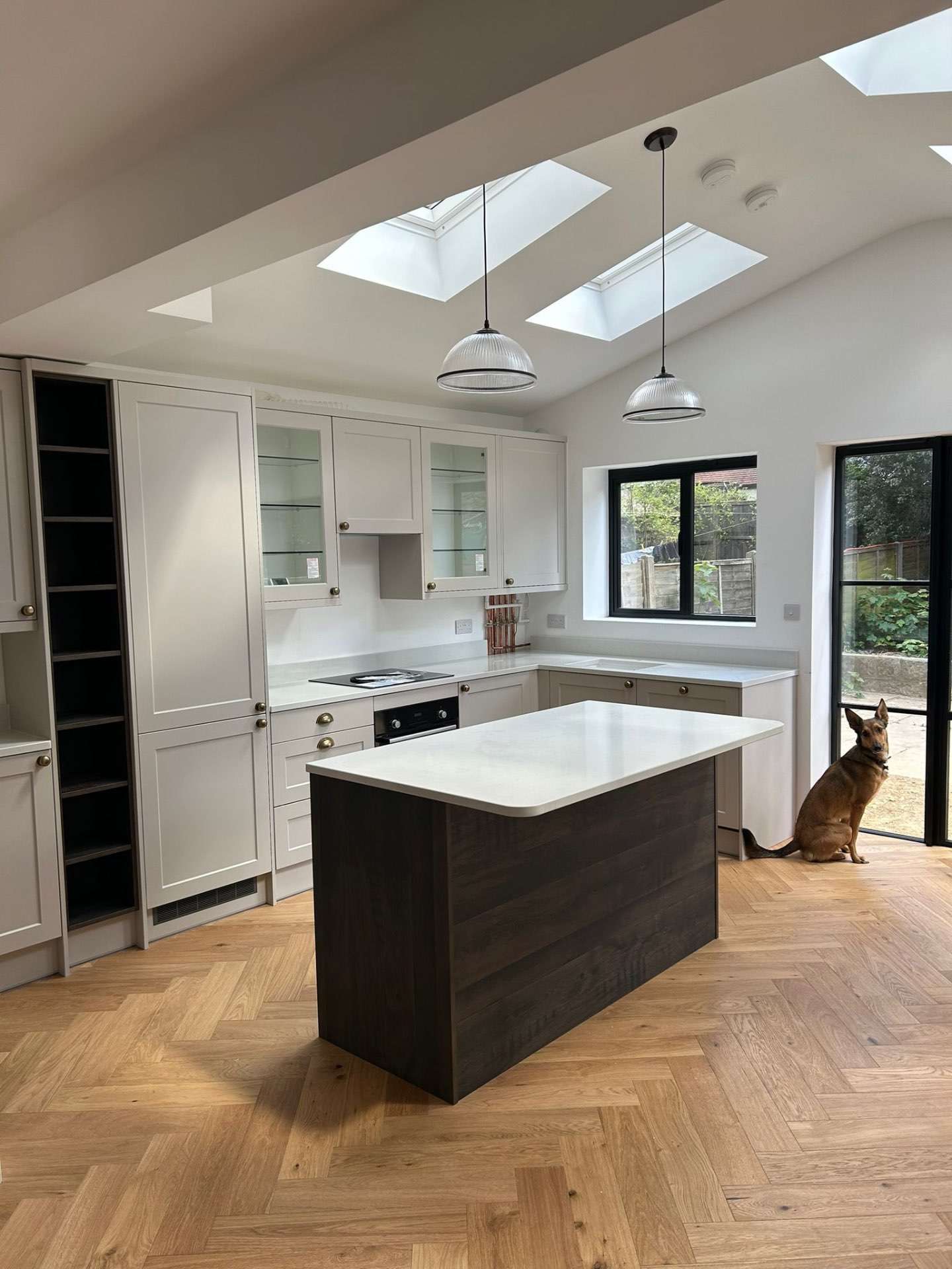 Kitchen with pitched-roof skylights above a central island