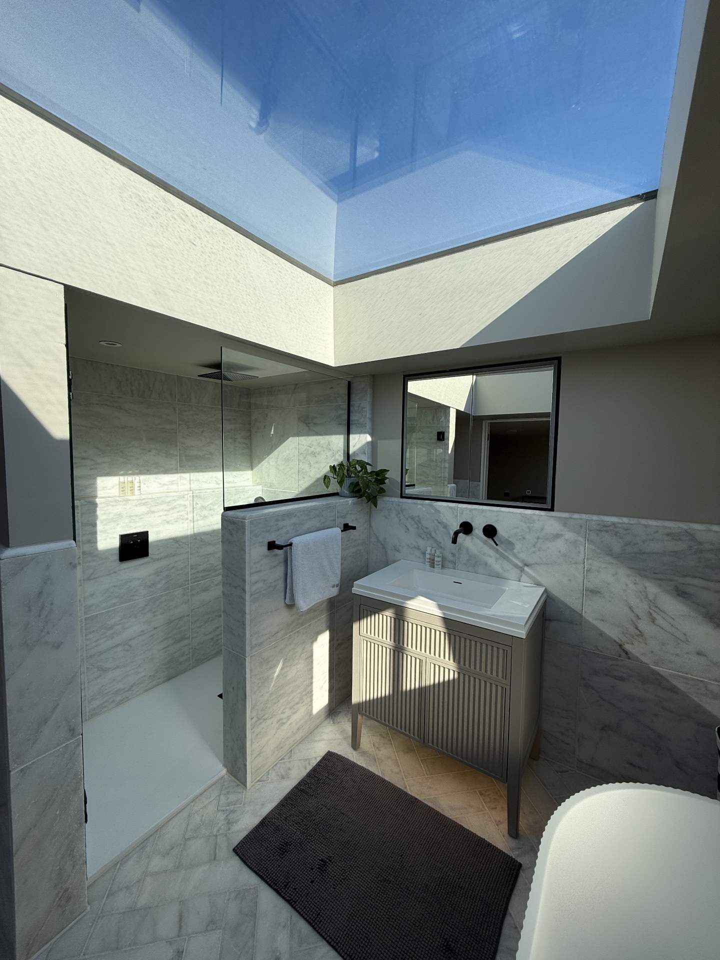Frameless flat rooflight above a loft shower room