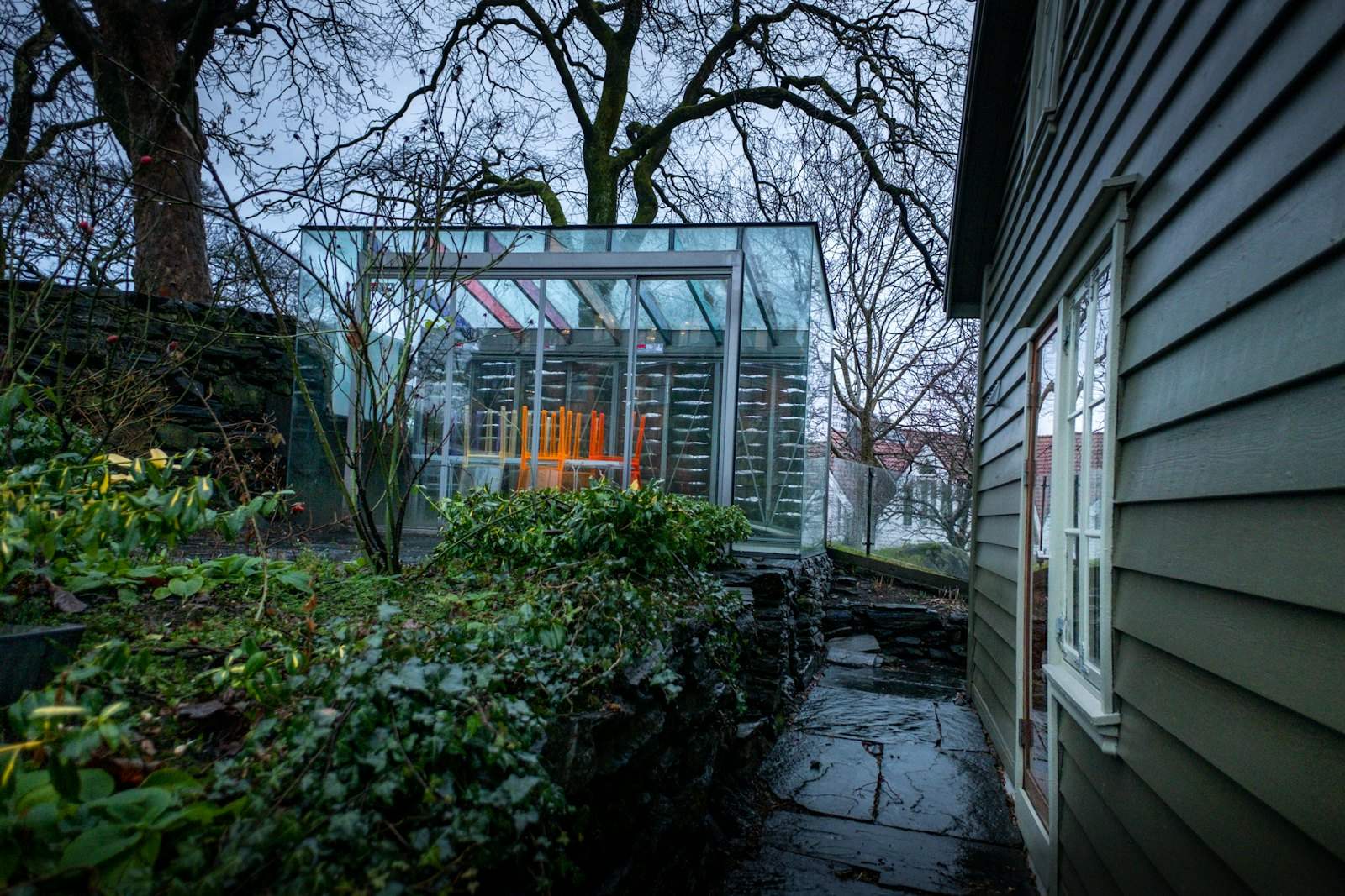 Glass garden building beside a house