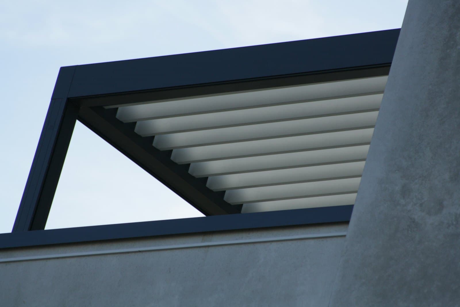 Louvred aluminium pergola roof against the sky
