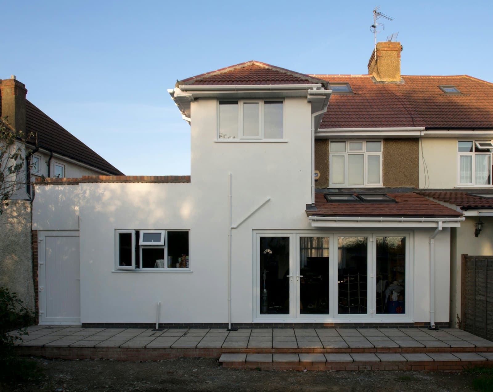 Semi-detached house with a freshly rendered white extension